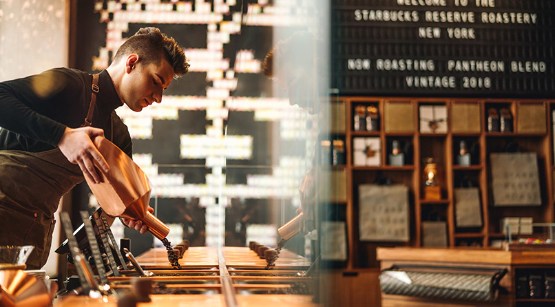 A person stands at a Roastery scoop bar, pouring coffee beans into a bin.