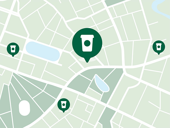 An illustrated map featuring drop pins marked with to-go coffee cups, indicating various Starbucks locations.
